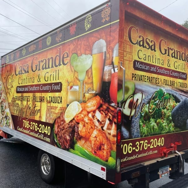 Casa Grande Cantina & Grill catering truck with vibrant images of Mexican food and drinks.