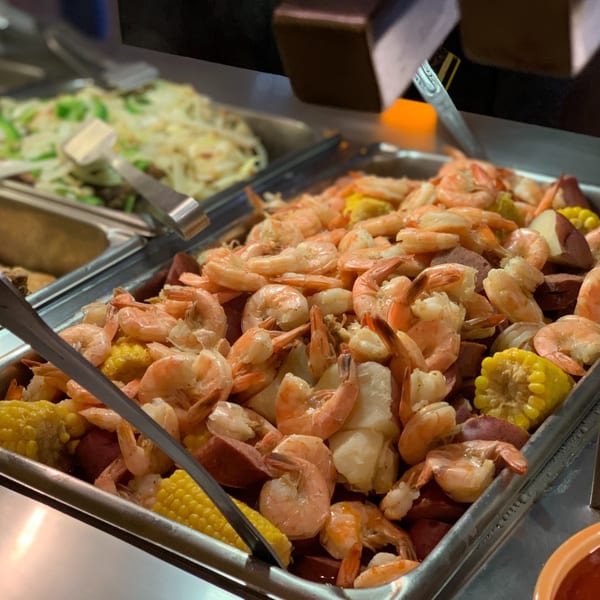 Shrimp, corn on the cob, and potatoes in a metal serving tray at Casa Grande Cantina & Grill.